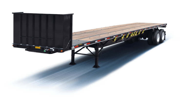 Flatbed trailer with yellow ratchet straps secured for transport